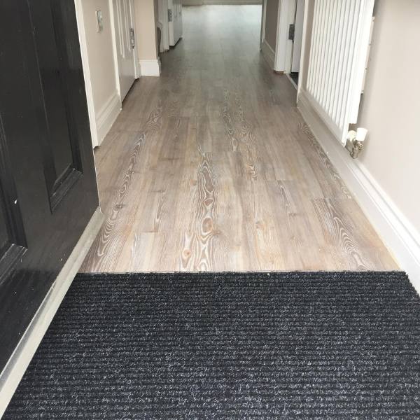 Amtico Spacia - Worn Ash - With Ribbed Matting installed in a hallway in Northampton