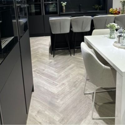 Beautiful kitchen diner fitted with versatile Studio Designs LVT flooring in colour county oak and laid herringbone style, in Northampton.