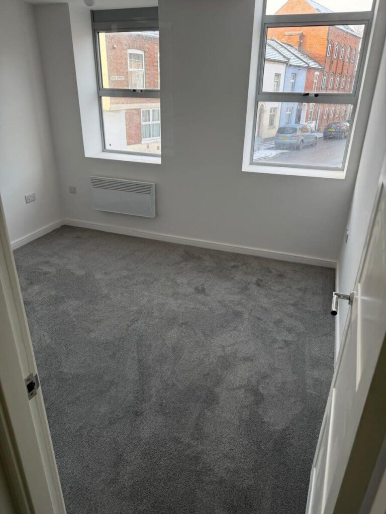 Grey Carpets installed in a bedroom at the flats at Allinson House in Northampton.