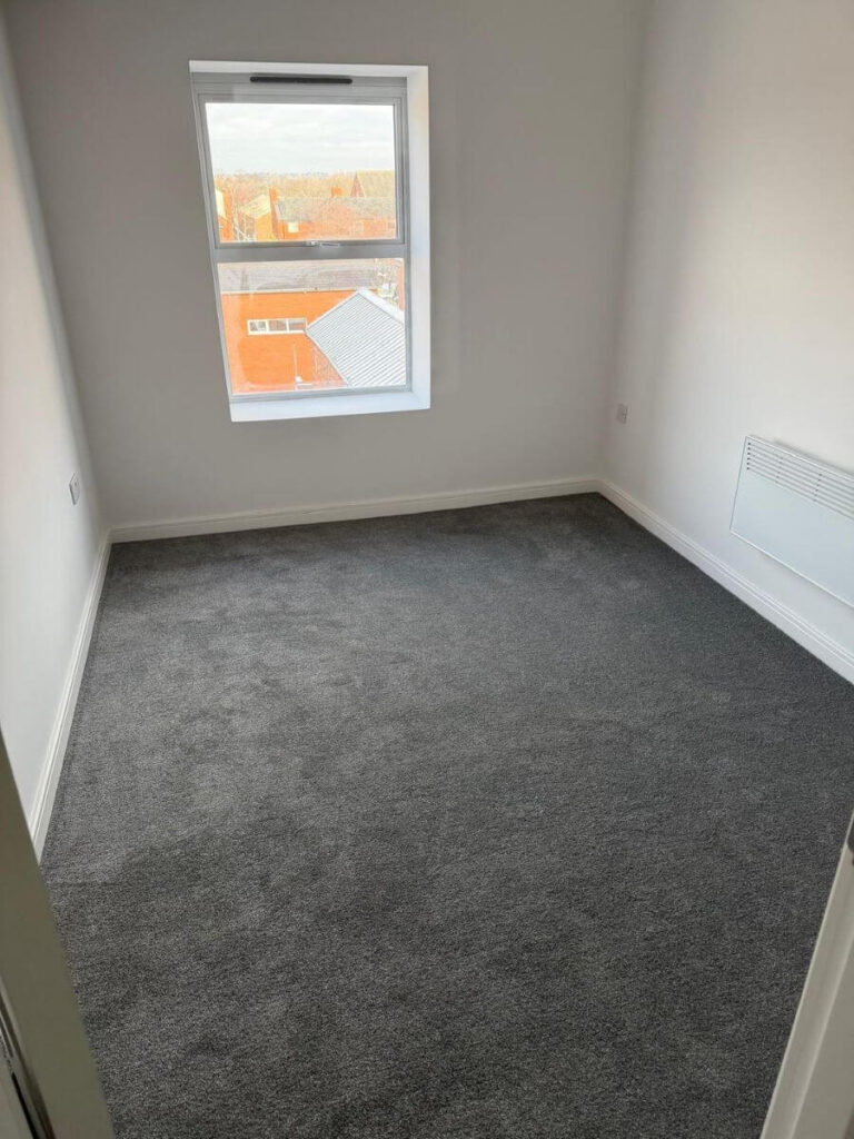 Grey Carpets installed in a bedroom at the flats at Allinson House in Northampton.