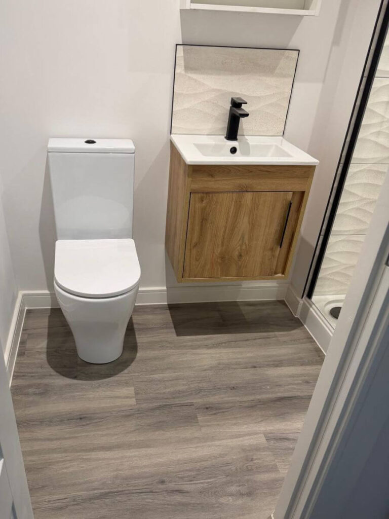 Grey vinyl tile flooring installed in a bathroom at the flats at Allinson House in Northampton.