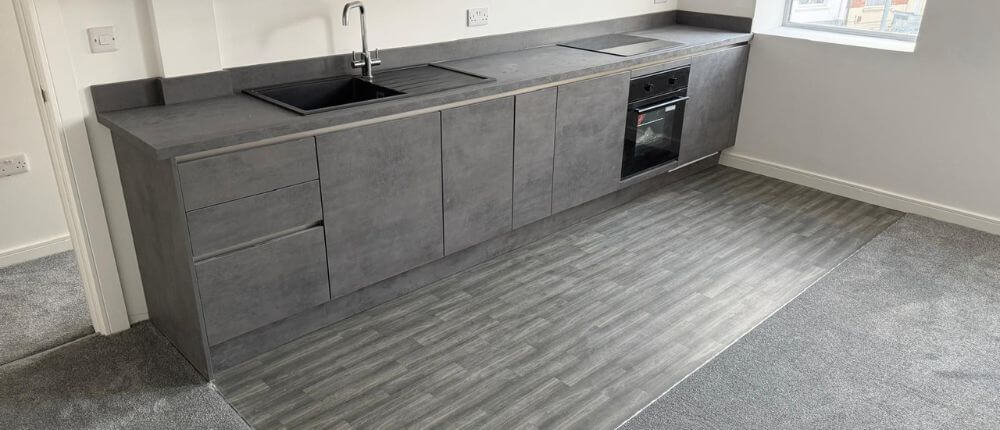 Grey vinyl tile flooring installed in the kitchen at the flats at Allinson House in Northampton.