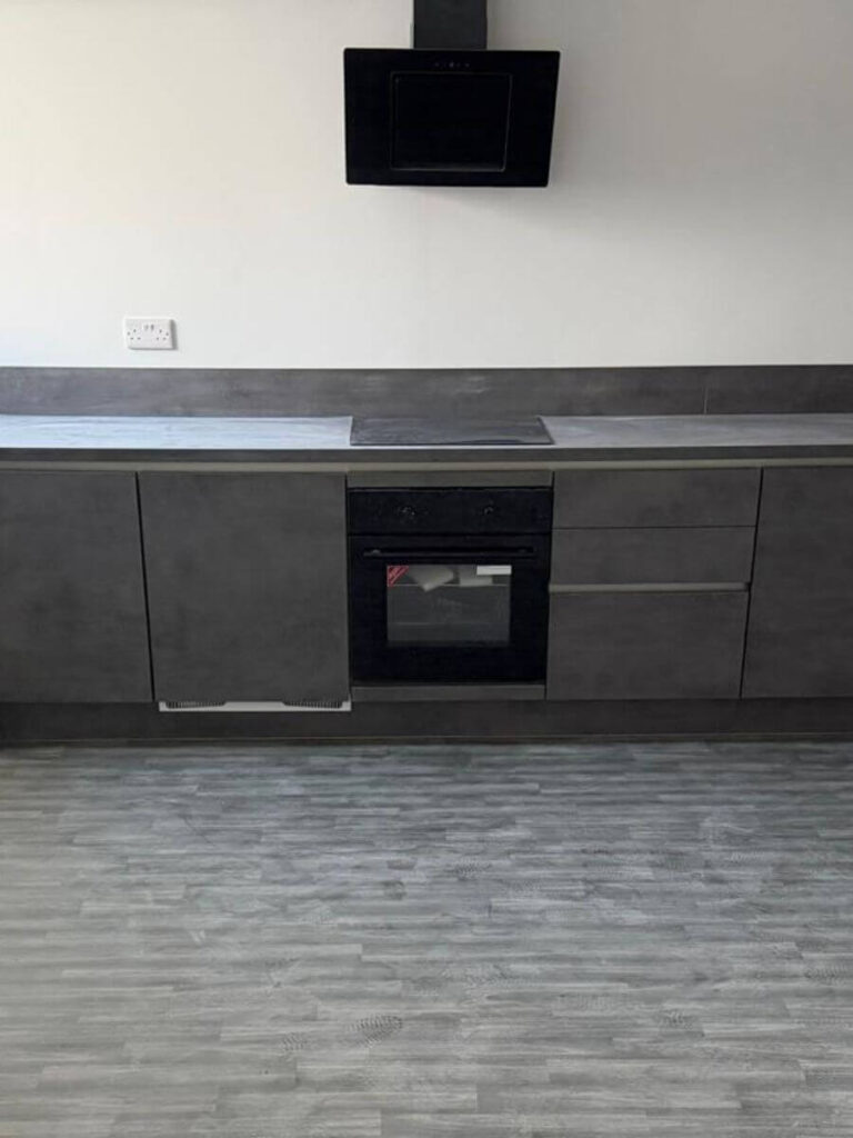 Grey vinyl tile flooring installed in the kitchen at the flats at Allinson House in Northampton.