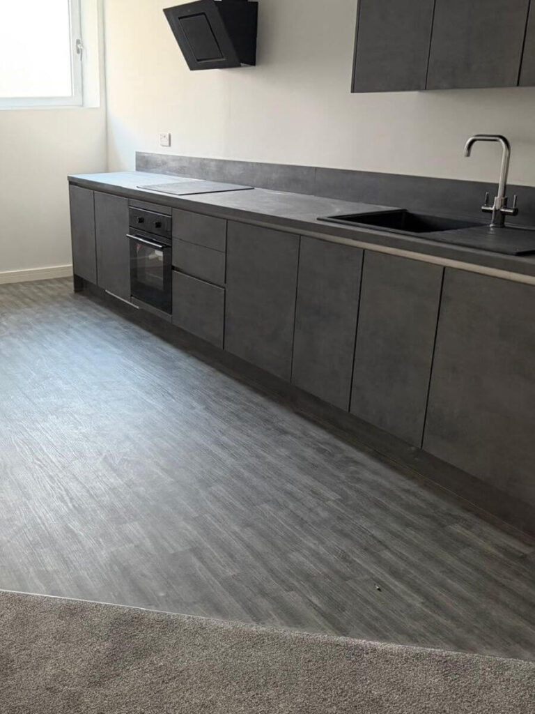 Grey vinyl tile flooring installed in the kitchen at the flats at Allinson House in Northampton.
