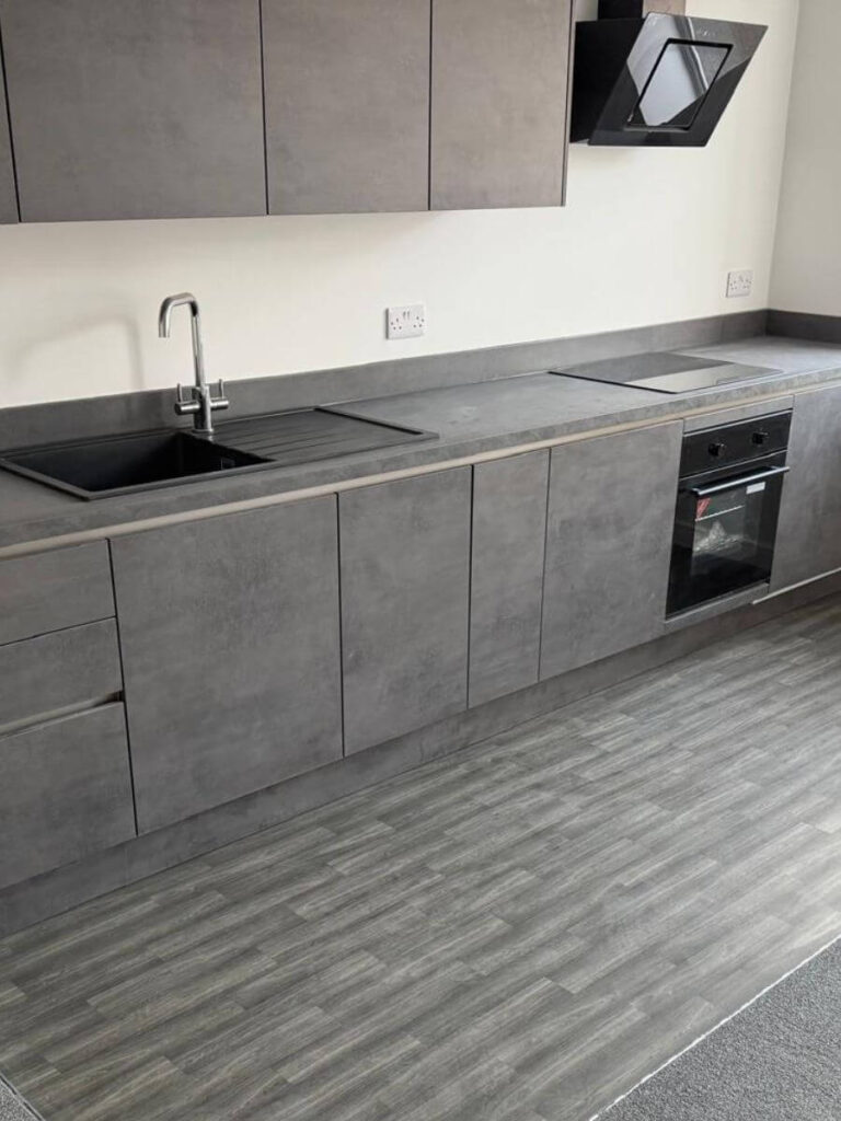 Grey vinyl tile flooring installed in the kitchen at the flats at Allinson House in Northampton.
